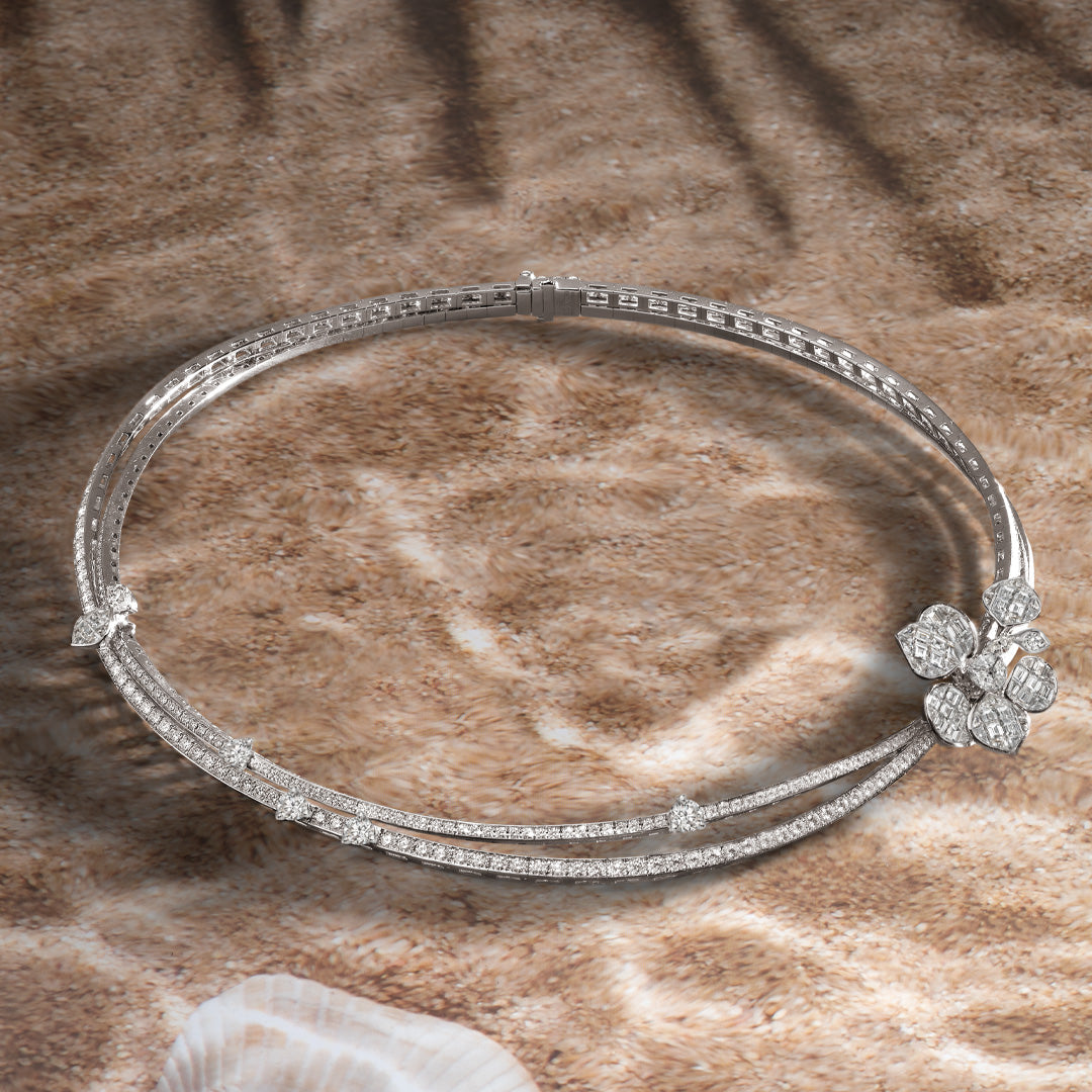 White gold diamond necklace on sand background